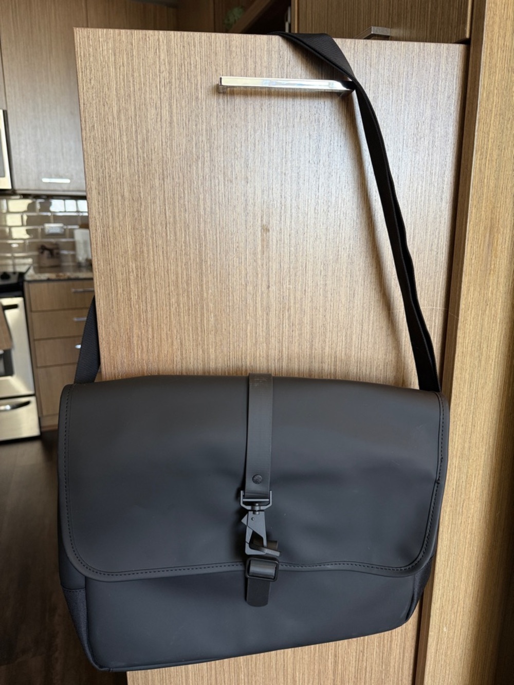 Rains Black Messenger Bag with Buckle Strap